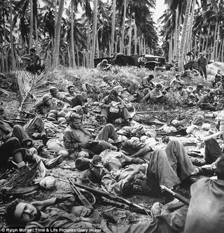 Exhausted US Marines on the beach at Guadalcanal